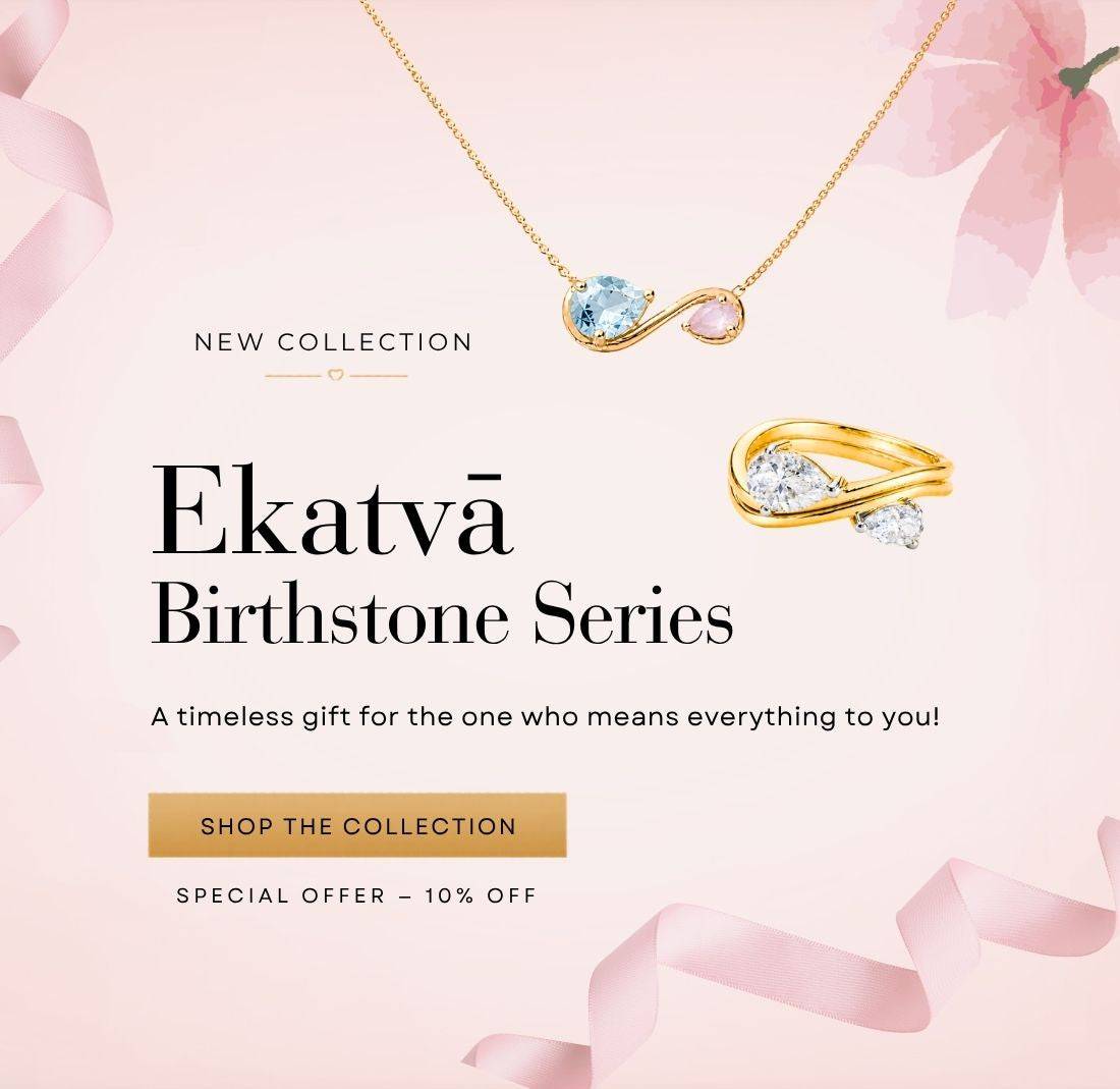 Homepage banner showcasing NIVI's Ekatvā Birthstone Series featuring a handcrafted birthstone necklace and matching ring crafted in 925 sterling silver with one-micron gold plating. The necklace displays two natural birthstones symbolizing the bond between mother and child, while the coordinating ring features sparkling gemstones in an elegant contemporary design. Set against a soft blush pink background with ribbon accents, the banner includes the message "New Collection – Ekatvā Birthstone Series" and the